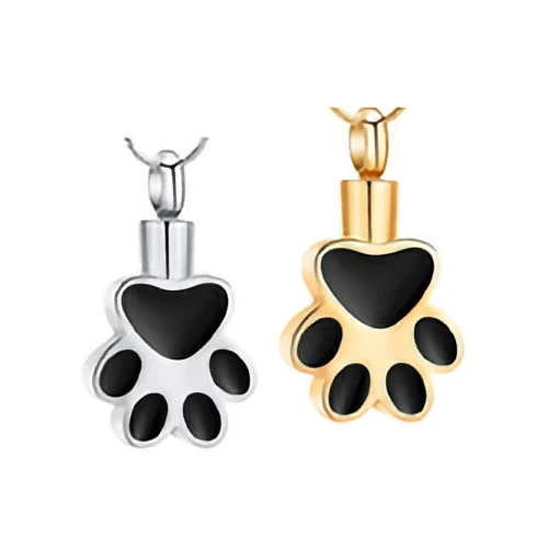 A silver and a gold paw print urn pendant for pet ashes, featuring black enamel pads.